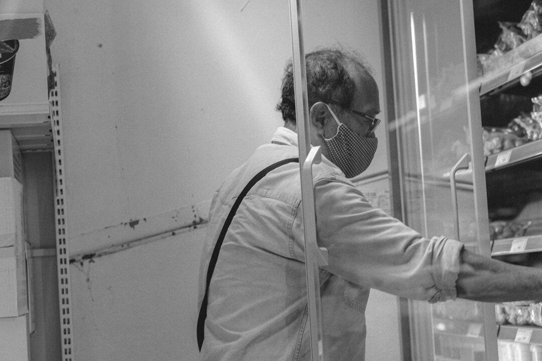 Instructor pointing at a whiteboard with a system architecture diagram