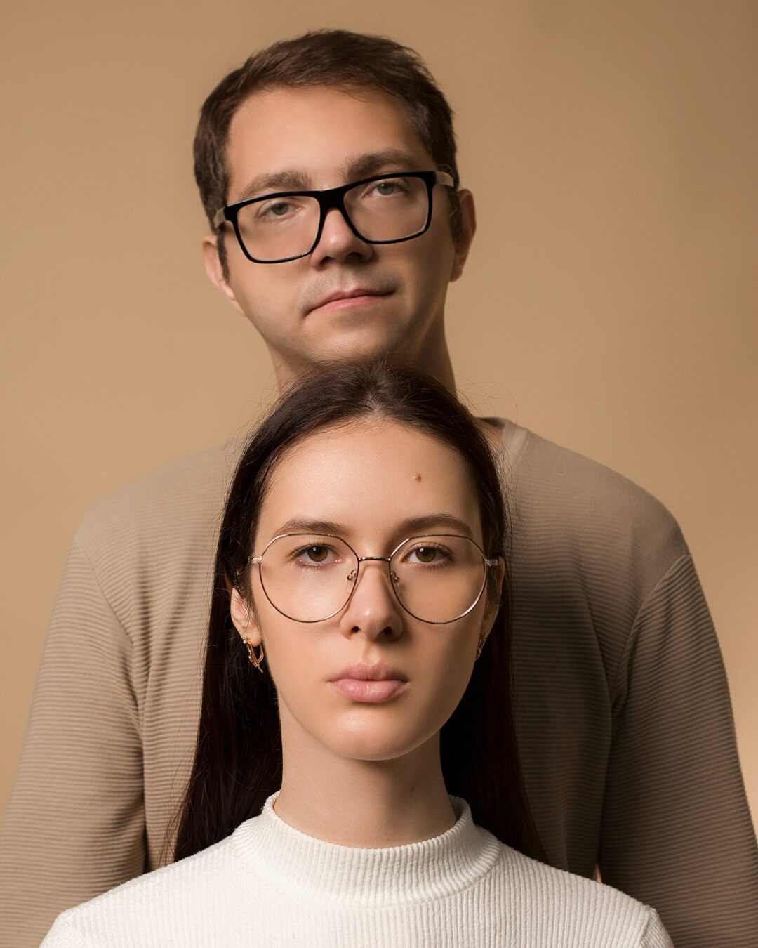 Studio portrait of a smiling Asian male instructor in glasses