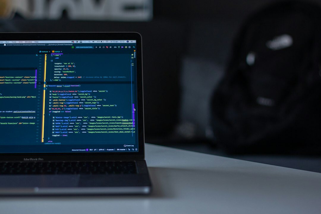 programmer coding on laptop