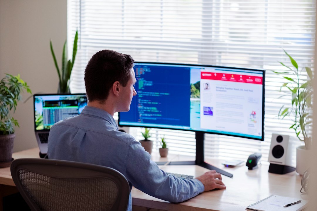 programmer at desk with code